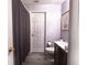 Bathroom features a vanity with a dark countertop, and shower/tub with a gray curtain at 117 Rosso Dr, Davenport, FL 33837