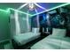 Themed bedroom with unique wall and ceiling lighting, twin beds and neutral bedding at 117 Rosso Dr, Davenport, FL 33837