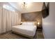 Well-lit bedroom features a king bed, accent wall, modern lighting and an oversized window at 117 Rosso Dr, Davenport, FL 33837