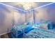 Themed bedroom with custom bedding, decorative curtains, and ambient ceiling lighting at 117 Rosso Dr, Davenport, FL 33837