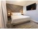 Stylish bedroom features a neutral palette, a decorative wall and a comfortable king-sized bed at 117 Rosso Dr, Davenport, FL 33837