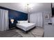 Cozy bedroom features a king bed, stylish wall decor, and decorative curtains at 117 Rosso Dr, Davenport, FL 33837