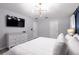 Bright bedroom features a king bed, stylish lighting, and a white dresser at 117 Rosso Dr, Davenport, FL 33837