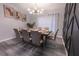 Stylish dining room with a modern chandelier, elegant table setting, and unique wall decor at 117 Rosso Dr, Davenport, FL 33837