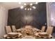 Sophisticated dining area with a set table, modern lighting, and an accent wall at 117 Rosso Dr, Davenport, FL 33837