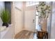 Inviting entryway with hardwood floors, a bright white door, and stylish decor at 117 Rosso Dr, Davenport, FL 33837