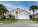 Charming single-Gathering home featuring a red tile roof, well-manicured lawn, and a two-car garage at 117 Rosso Dr, Davenport, FL 33837