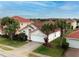 Well-maintained single-Gathering home featuring a tile roof, lush landscaping, and an attached two-car garage at 117 Rosso Dr, Davenport, FL 33837