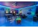 Brightly lit game room features multiple arcade games and ample seating at 117 Rosso Dr, Davenport, FL 33837