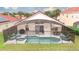 Screened-in pool area featuring a pool, hot tub, lounge chairs, and an outdoor dining set at 117 Rosso Dr, Davenport, FL 33837