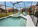 A close up of a screened-in pool and hot tub area with lounge chairs at 117 Rosso Dr, Davenport, FL 33837
