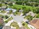 Aerial view of neighborhood featuring lovely homes, cul-de-sac, lush green spaces, and a serene pond at 12929 Louisiana Woods Ct, Orlando, FL 32824