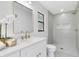 Modern bathroom with white vanity, sleek fixtures, herringbone shower tile, and window providing natural light at 12929 Louisiana Woods Ct, Orlando, FL 32824