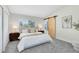 Serene bedroom featuring a sliding barn door, neutral decor, and ample natural light from a large window at 12929 Louisiana Woods Ct, Orlando, FL 32824