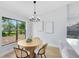 Elegant dining space with stylish chandelier, a large window with backyard views, and modern decor at 12929 Louisiana Woods Ct, Orlando, FL 32824