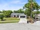 Beautifully landscaped single-Gathering home boasts an attached two-car garage and large driveway at 12929 Louisiana Woods Ct, Orlando, FL 32824