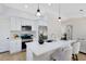 Modern kitchen with white cabinetry, stainless steel appliances, quartz counters, and pendant lighting at 12929 Louisiana Woods Ct, Orlando, FL 32824