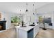 Bright eat-in kitchen with quartz counters, an island with breakfast bar, and a cozy banquette at 12929 Louisiana Woods Ct, Orlando, FL 32824