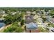This aerial shot features houses with diverse roof colors, streets, and lush green trees in the neighborhood at 12952 Downstream Cir, Orlando, FL 32828
