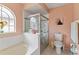 Bathroom with shower, tub, tile, and stylish window offering natural light at 12952 Downstream Cir, Orlando, FL 32828