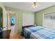 Comfortable bedroom with a blue plaid bedspread and a large closet, offering a calm retreat at 12952 Downstream Cir, Orlando, FL 32828