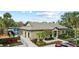 Stunning clubhouse exterior with lush landscaping, mature palms, with an adjacent pool at 12952 Downstream Cir, Orlando, FL 32828