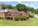 Welcome to Waterbury: A beautifully landscaped community entrance with a brick sign and lush greenery at 12952 Downstream Cir, Orlando, FL 32828