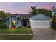 Charming single-Gathering home with a manicured lawn, two-car garage, and freshly painted exterior at 12952 Downstream Cir, Orlando, FL 32828