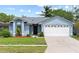 Charming one-story home with a well-manicured lawn and attached two-car garage at 12952 Downstream Cir, Orlando, FL 32828