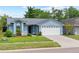 Charming single-Gathering home with well-manicured lawn and attached garage, offering great curb appeal at 12952 Downstream Cir, Orlando, FL 32828