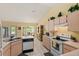Bright eat-in kitchen with white appliances and tile flooring adjacent to dining area at 12952 Downstream Cir, Orlando, FL 32828