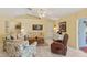 Spacious living room with tile flooring, vaulted ceilings, and comfortable, floral furniture at 12952 Downstream Cir, Orlando, FL 32828