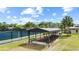 View of tennis courts and a gym, as well as well manicured grass and palm trees at 12952 Downstream Cir, Orlando, FL 32828