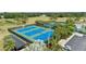 Aerial view of tennis courts and parking, surrounded by lush greenery, offering recreational opportunities at 12952 Downstream Cir, Orlando, FL 32828