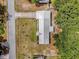 An aerial view of a single Gathering home with a light-colored roof and a spacious front yard at 13009 Plum Lake Cir, Minneola, FL 34715