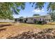 Spacious backyard featuring a white home with a screened in lanai at 13009 Plum Lake Cir, Minneola, FL 34715