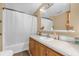Bright bathroom featuring a tub with shower, vanity, and neutral color scheme at 13009 Plum Lake Cir, Minneola, FL 34715