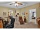 Cozy bedroom with ceiling fan, neutral walls, and door leading to additional living areas at 13009 Plum Lake Cir, Minneola, FL 34715
