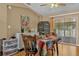 Cozy dining room with hardwood floors, table, birdcage, and patio access at 13009 Plum Lake Cir, Minneola, FL 34715