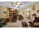 Comfortable home office featuring carpet flooring, ceiling fan, and wooden desk with shelving at 13009 Plum Lake Cir, Minneola, FL 34715