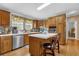Modern kitchen features stainless steel appliances, an island and wood cabinets at 13009 Plum Lake Cir, Minneola, FL 34715