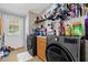 Organized laundry room with modern washer and dryer, ample storage and a convenient folding area at 13009 Plum Lake Cir, Minneola, FL 34715