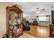 Spacious living room with hardwood floors, modern sofas, and a decorative display cabinet at 13009 Plum Lake Cir, Minneola, FL 34715