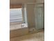 Shower and tub combination with tile surround in vacant bathroom at 13543 Emeraldview Dr, Orlando, FL 32828