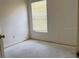 This cozy bedroom features natural light, offering a simple and inviting space at 13543 Emeraldview Dr, Orlando, FL 32828