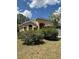 Beige one story home with mature shrubs in front yard under sunny skies at 13543 Emeraldview Dr, Orlando, FL 32828