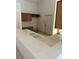 Outdated kitchen with white countertops and brown cabinets at 13543 Emeraldview Dr, Orlando, FL 32828