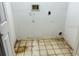 Functional laundry area with tile flooring, ready for customization at 13543 Emeraldview Dr, Orlando, FL 32828