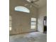 Vacant room with a high ceiling, windows, and view into another room at 13543 Emeraldview Dr, Orlando, FL 32828