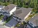 Aerial view of a two-story home with a brick driveway and balcony overlooking the neighborhood at 14138 Alafaya Oak Bnd, Orlando, FL 32828
